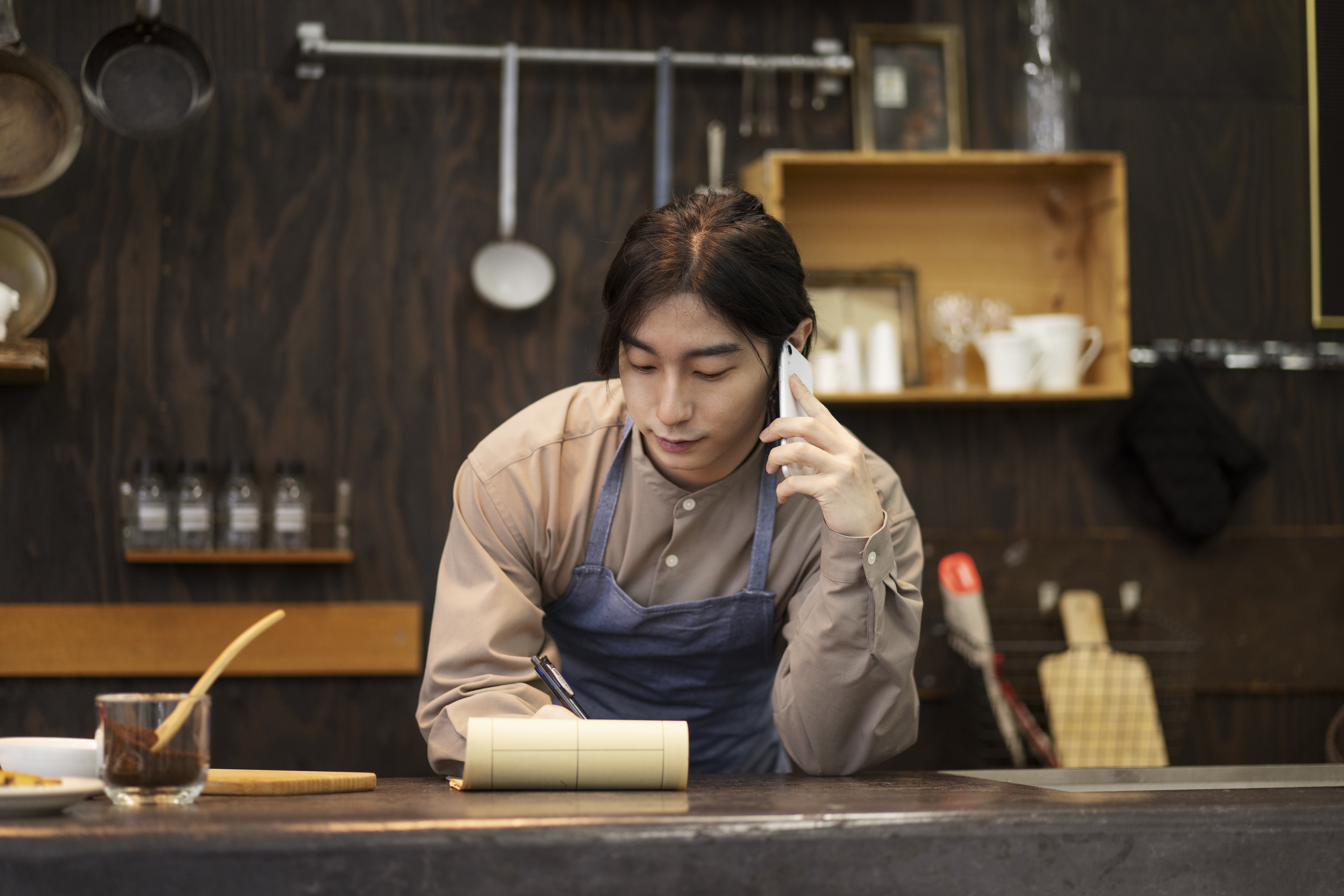 Small business owner reviewing records while preparing a service inquiry.